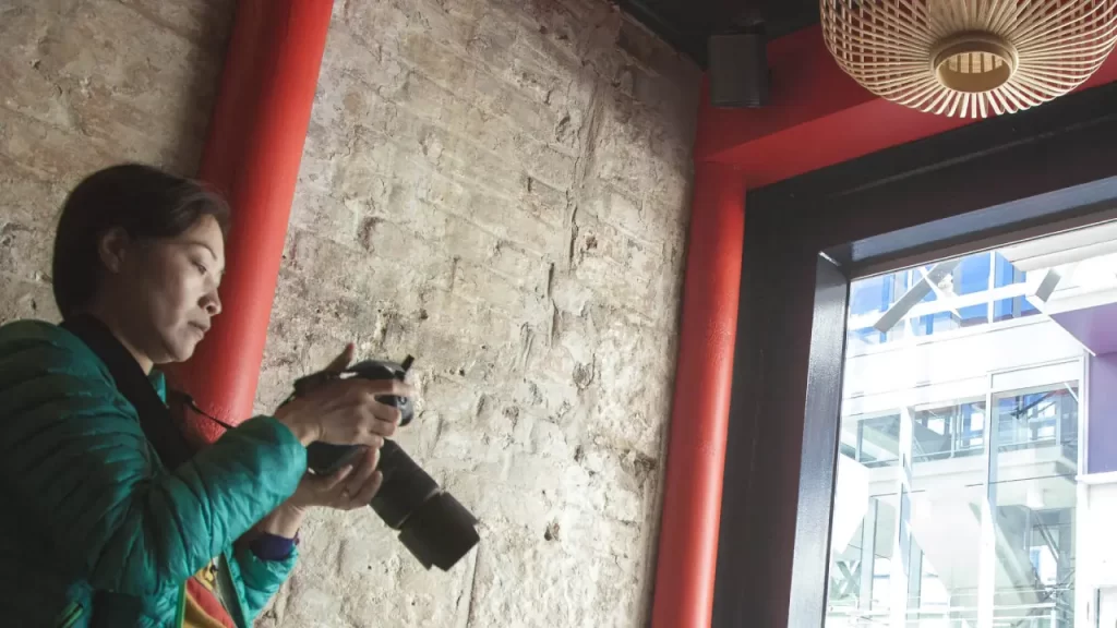 woman looking at digital camera screen